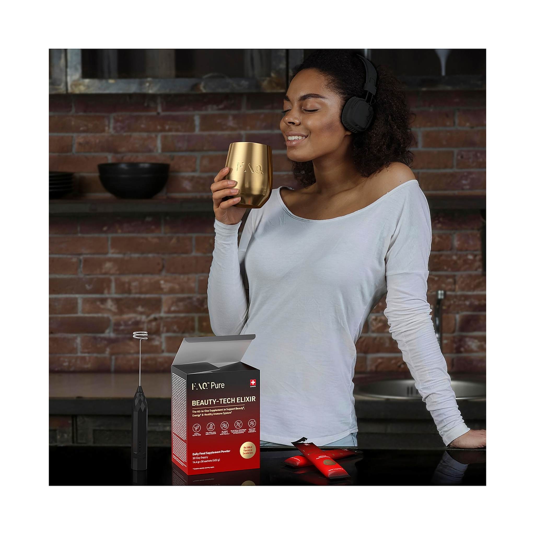 Woman enjoying FAQ Pure Beauty-Tech Elixir in gold cup