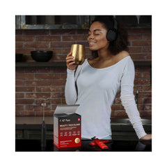 Woman enjoying FAQ Pure Beauty-Tech Elixir in gold cup
