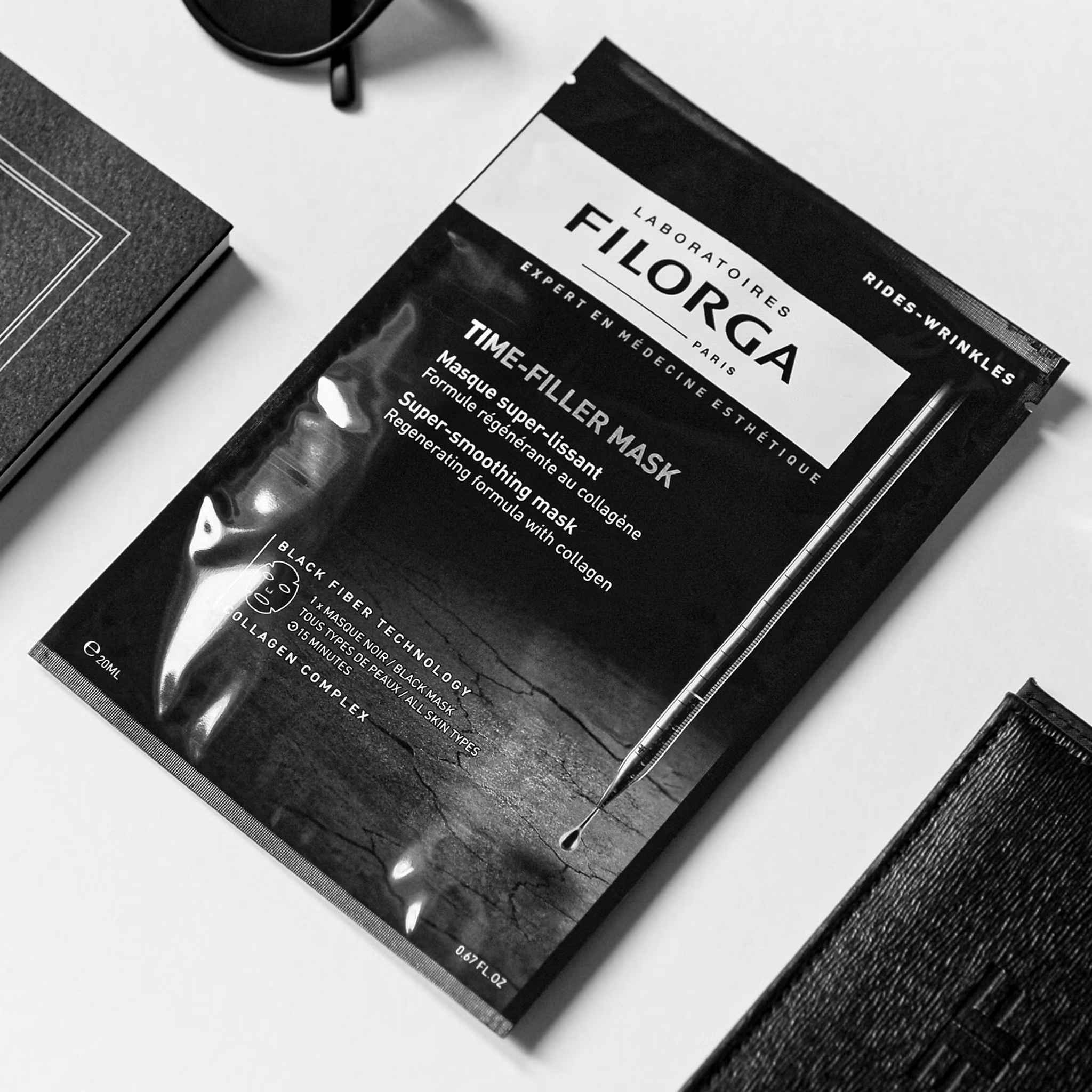 Filorga Time-Filler Mask black packet flatlay with accessories lifestyle editorial shot