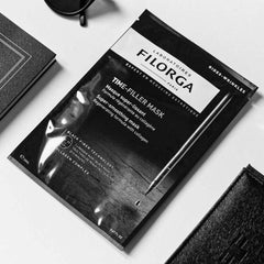 Filorga Time-Filler Mask black packet flatlay with accessories lifestyle editorial shot