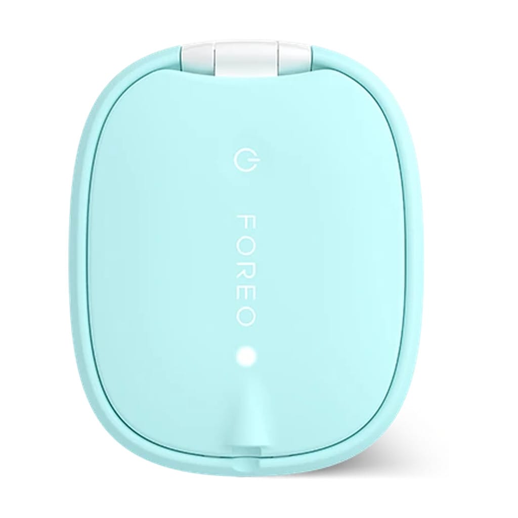 Back of FOREO FLIP LED hair brush in mint showing power button and LED indicator on smooth silicone shell