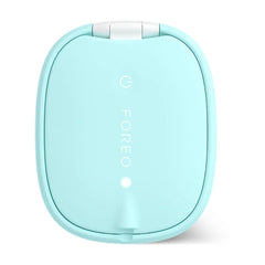 Back of FOREO FLIP LED hair brush in mint showing power button and LED indicator on smooth silicone shell