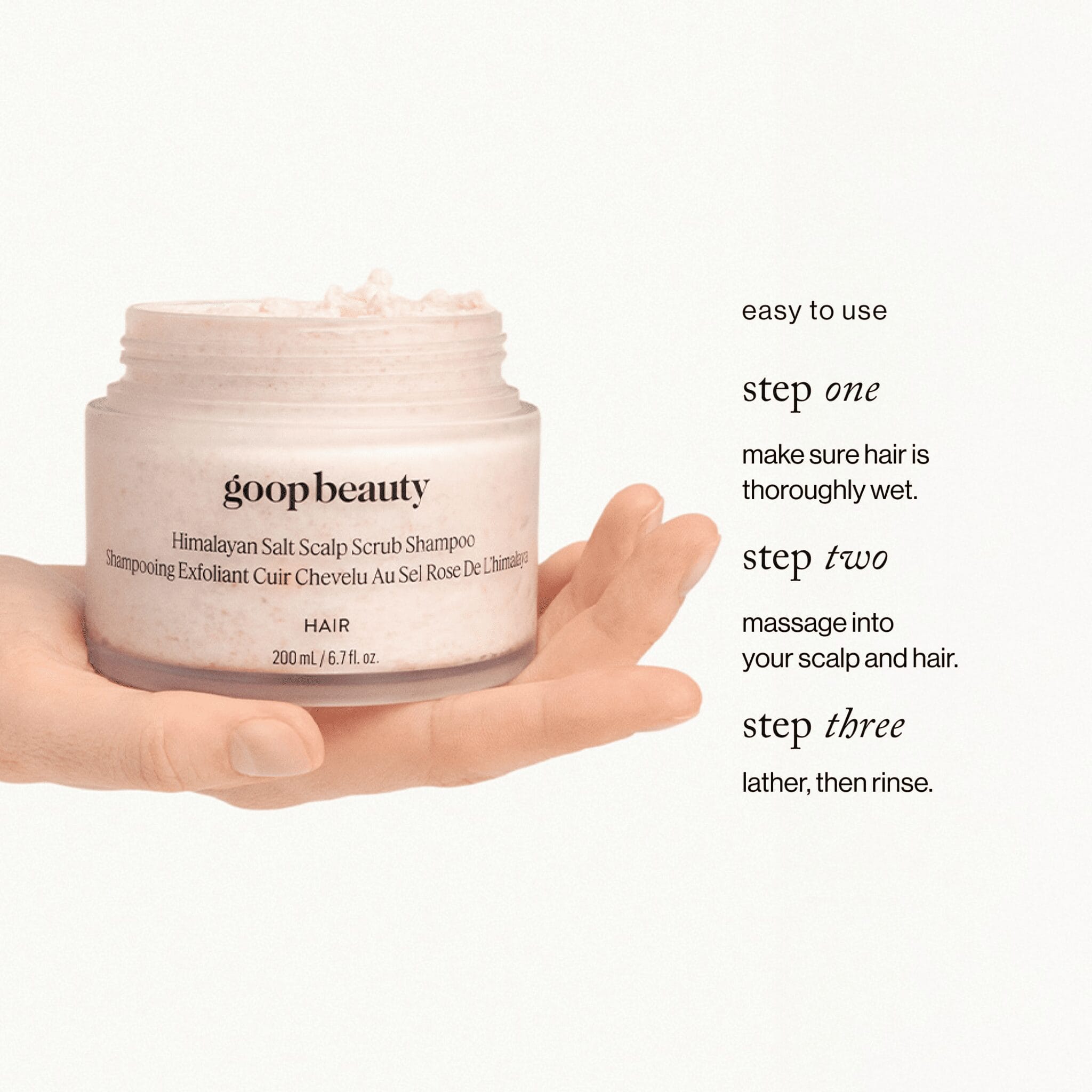 goop beauty Himalayan Salt Scalp Scrub Shampoo open jar in hand showing 3-step how-to application guide