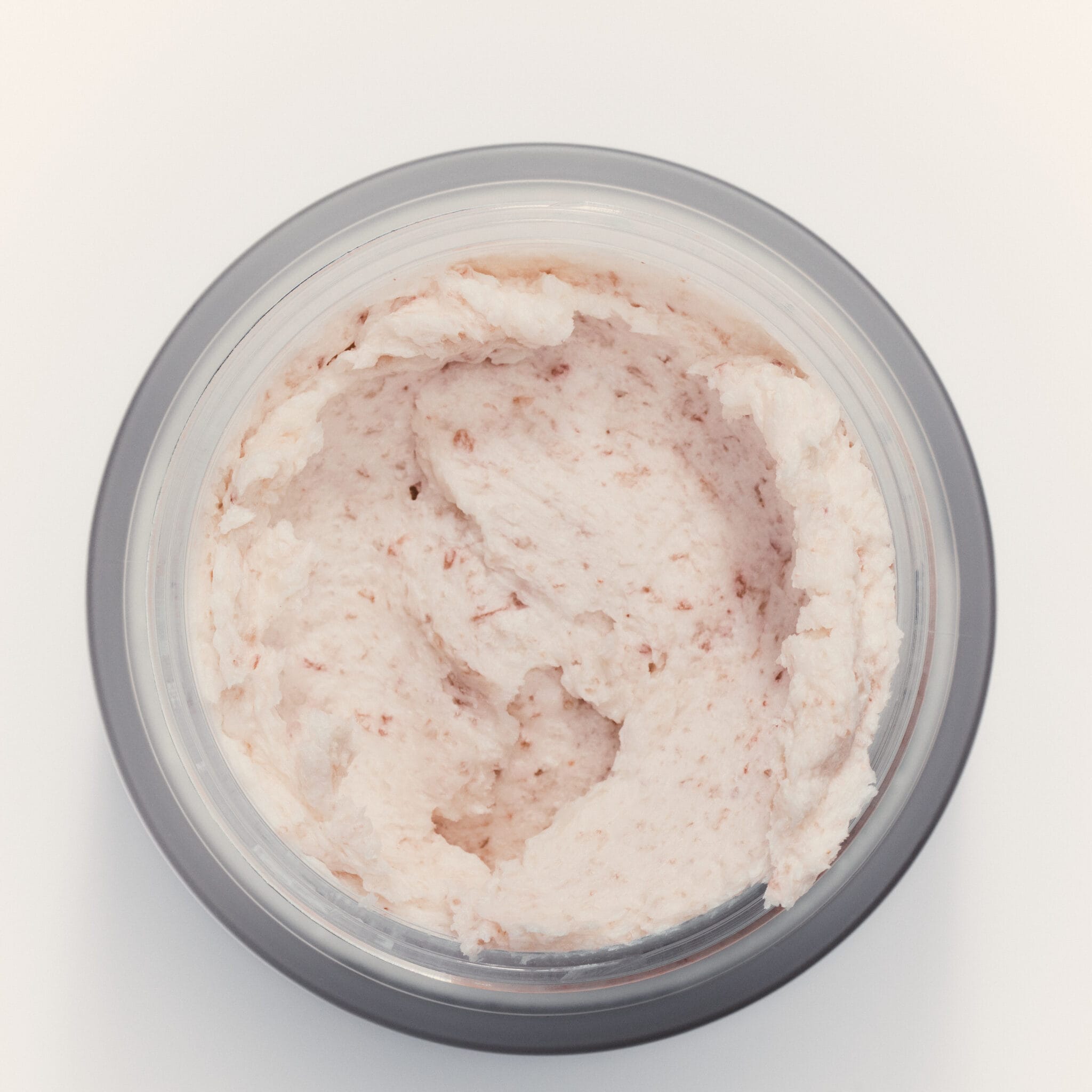 Open jar of goop beauty Himalayan Salt Scalp Scrub Shampoo showing pink salt scrub texture
