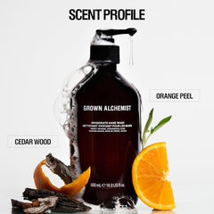Grown Alchemist hand wash bottle with orange peel and cedar wood elements on a white background