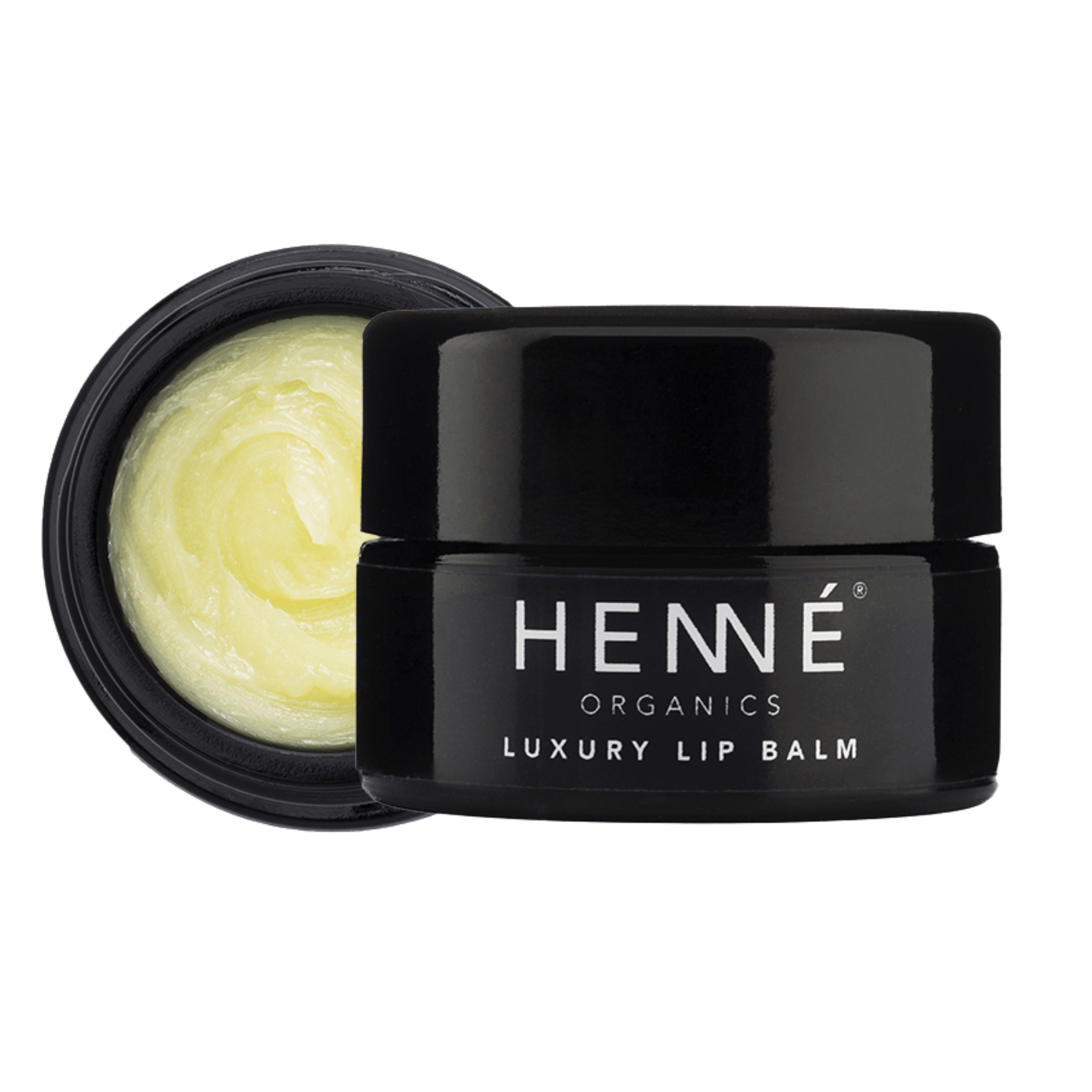 Henné Organics Luxury Lip Balm black glass jar beside its open lid showing creamy pale yellow balm