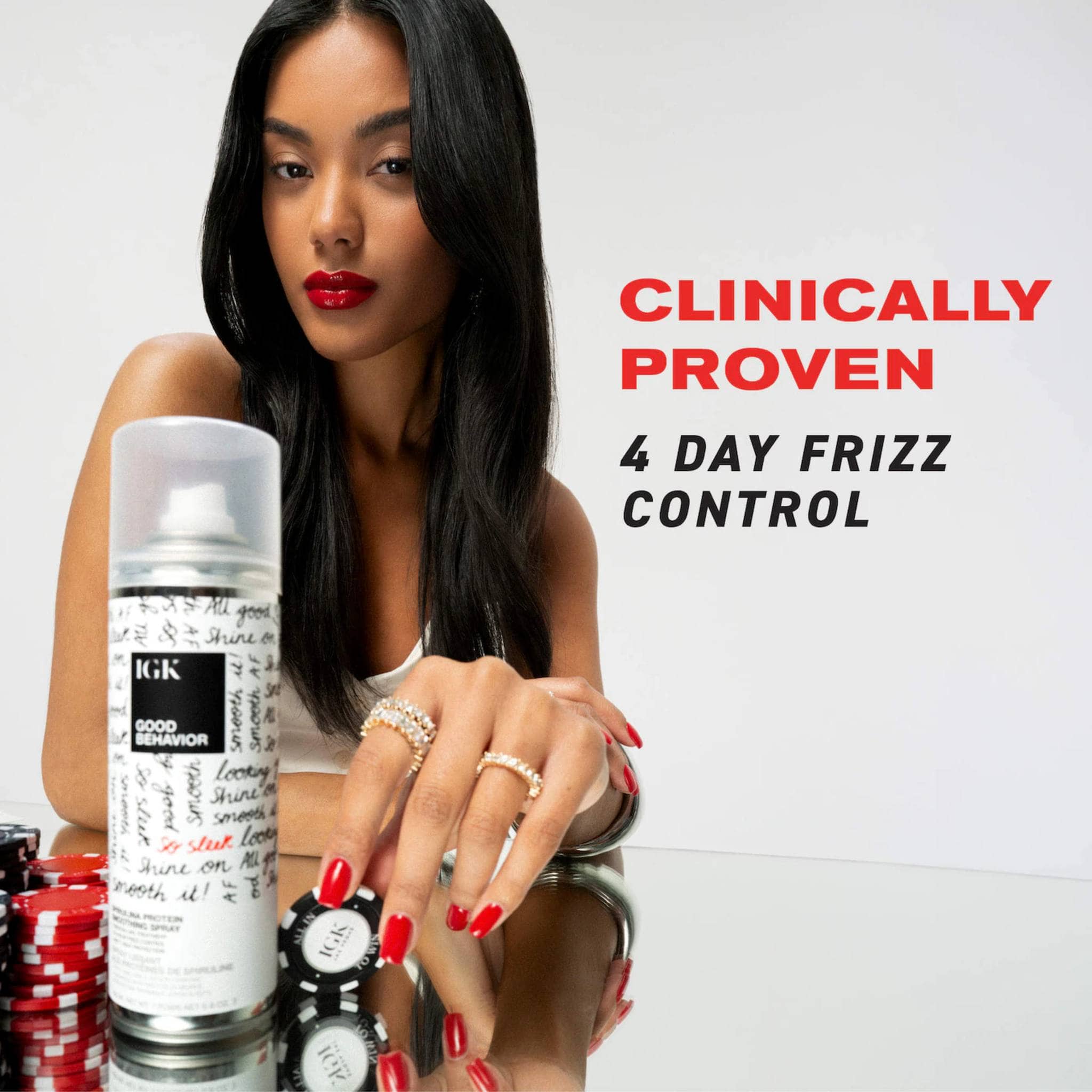 Model with sleek straight hair beside IGK Good Behavior clinically proven anti-frizz smoothing spray