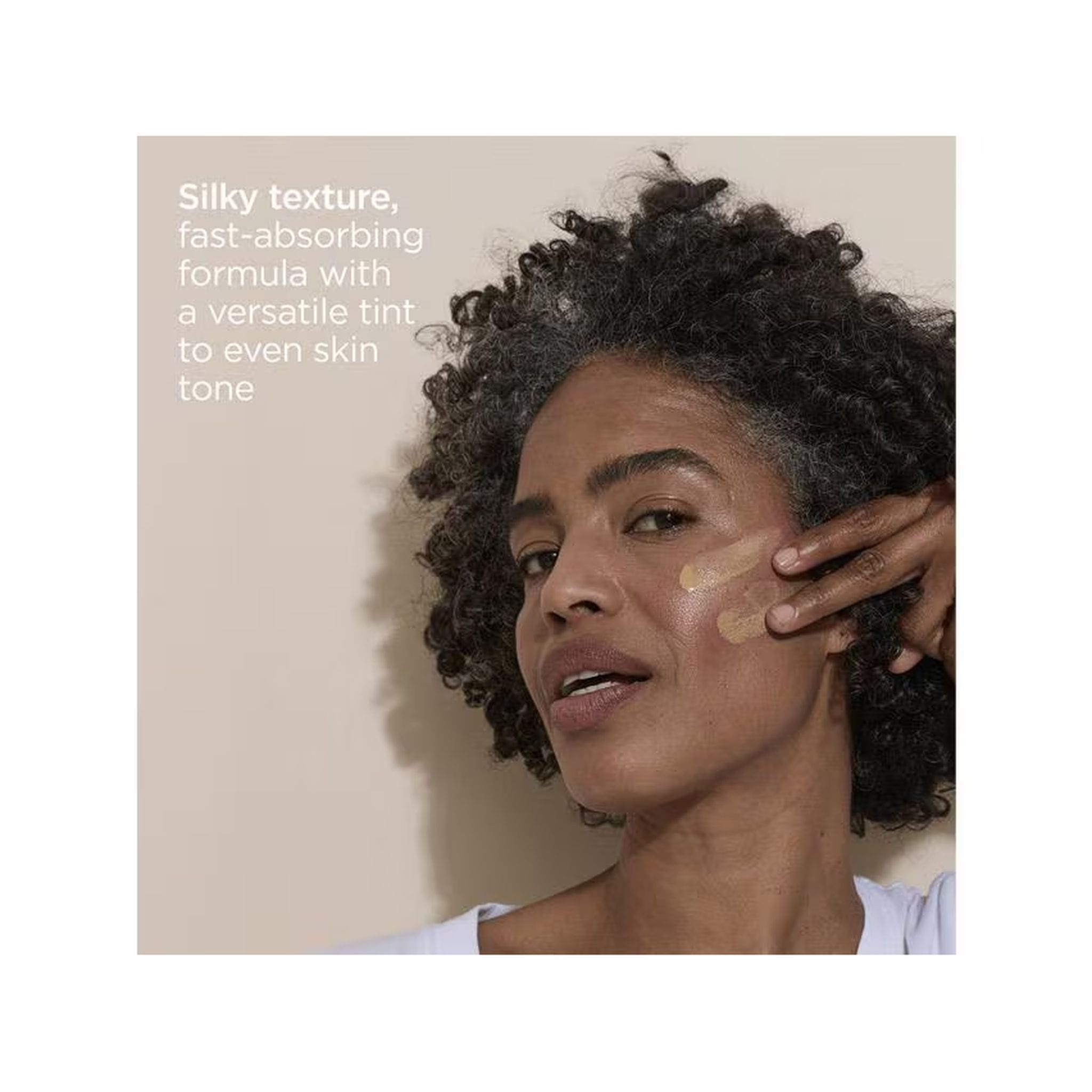 Silky fast-absorbing tinted sunscreen applied to skin