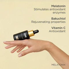 Hand holding ISDIN Melatonik serum with melatonin bakuchiol and vitamin C antioxidant ingredients