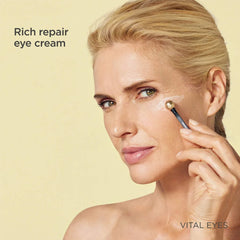 Woman applying ISDIN Vital Eyes rich repair eye cream under the eye with a gold-tipped massaging applicator