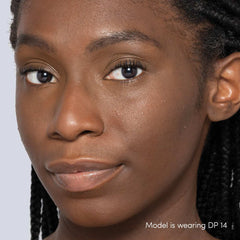 Jane Iredale Skintuition Liquid Concealer DP14 deep with peach undertones worn on model with glowing skin 3