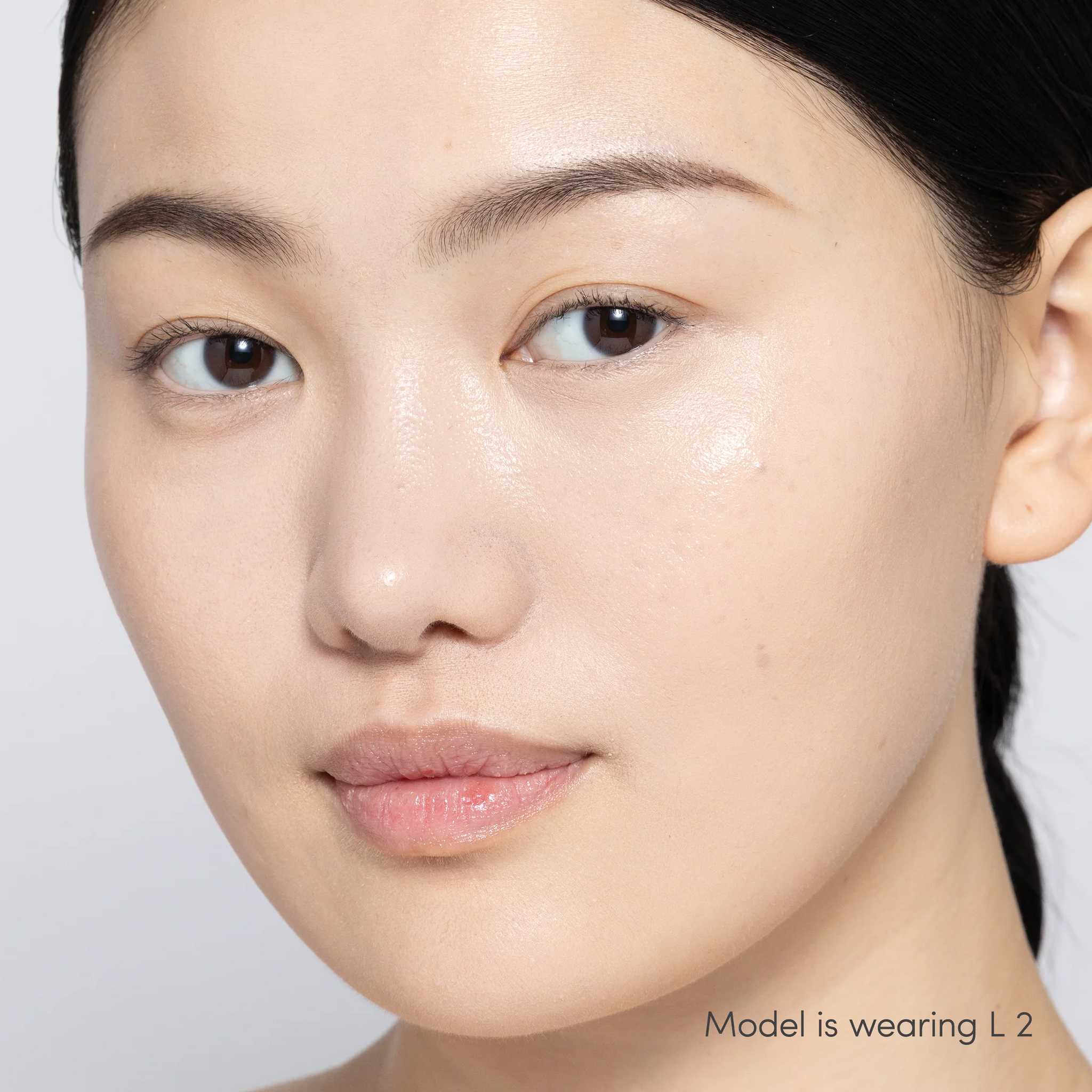 Jane Iredale Skintuition Liquid Concealer L2 - light with pink undertones worn on model with glowing skin 3