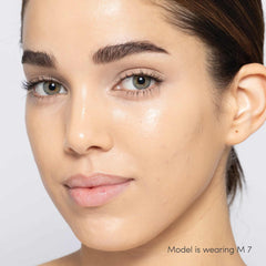 Jane Iredale Skintuition Liquid Concealer M7 - medium with peach undertones worn on model with glowing skin 3