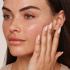 Model applying Jane Iredale Smooth Affair Brightening Face Primer to cheek