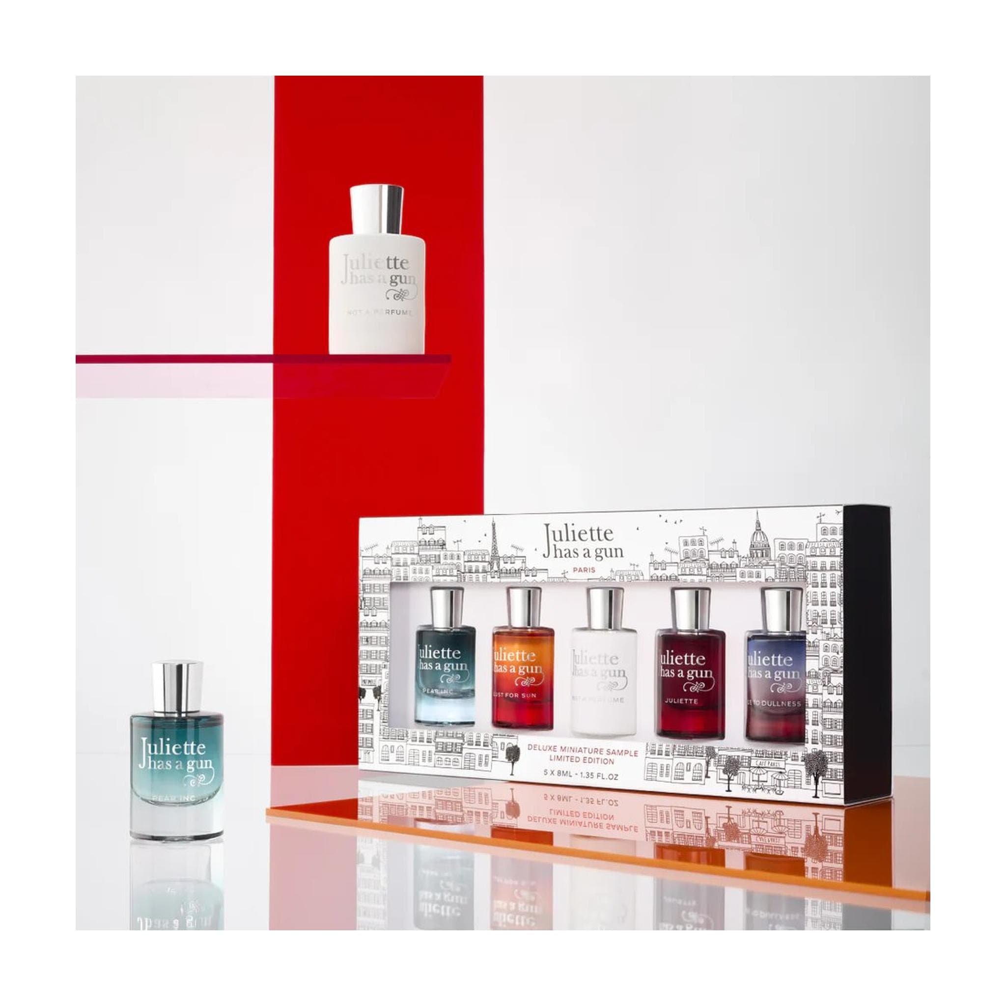 Juliette Has a Gun Deluxe Miniature Limited Edition fragrance gift set with Not a Perfume and Pear Inc mini bottles styled on red shelf