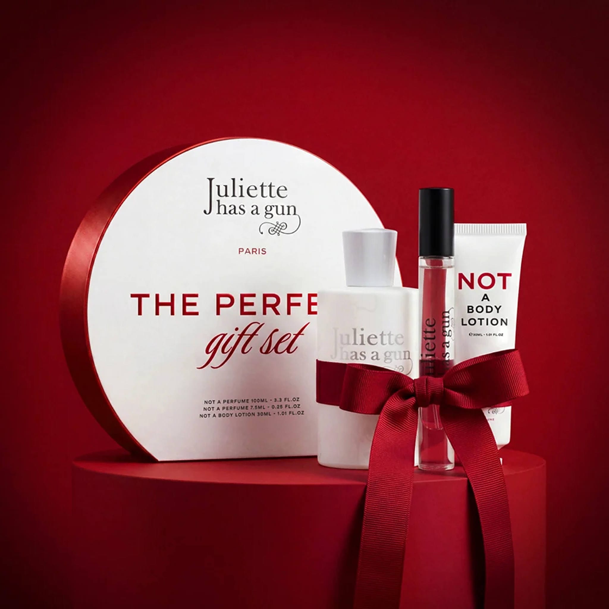 Juliette Has a Gun The Perfect Gift Set tied with a red ribbon on a red pedestal for holiday gifting (100)
