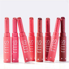 Eight Legendary Serum Lipstick shades standing upright with water droplets 8