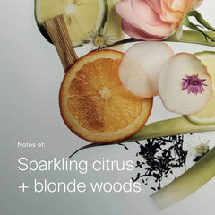 Orange slices rose petals and blonde wood showing the citrus and blonde woods scent of Living Proof Curl Conditioner