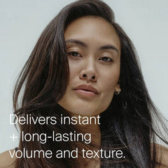 Woman with long voluminous dark hair showing instant long lasting volume and texture from Living Proof Full Dry Volume Spray