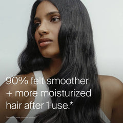 Woman with long glossy dark hair showing Living Proof Moisture Rescue Mask for smoother more moisturized hair