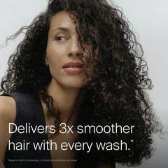 Woman with long defined curls showing Living Proof No Frizz Conditioner for 3x smoother hair with every wash