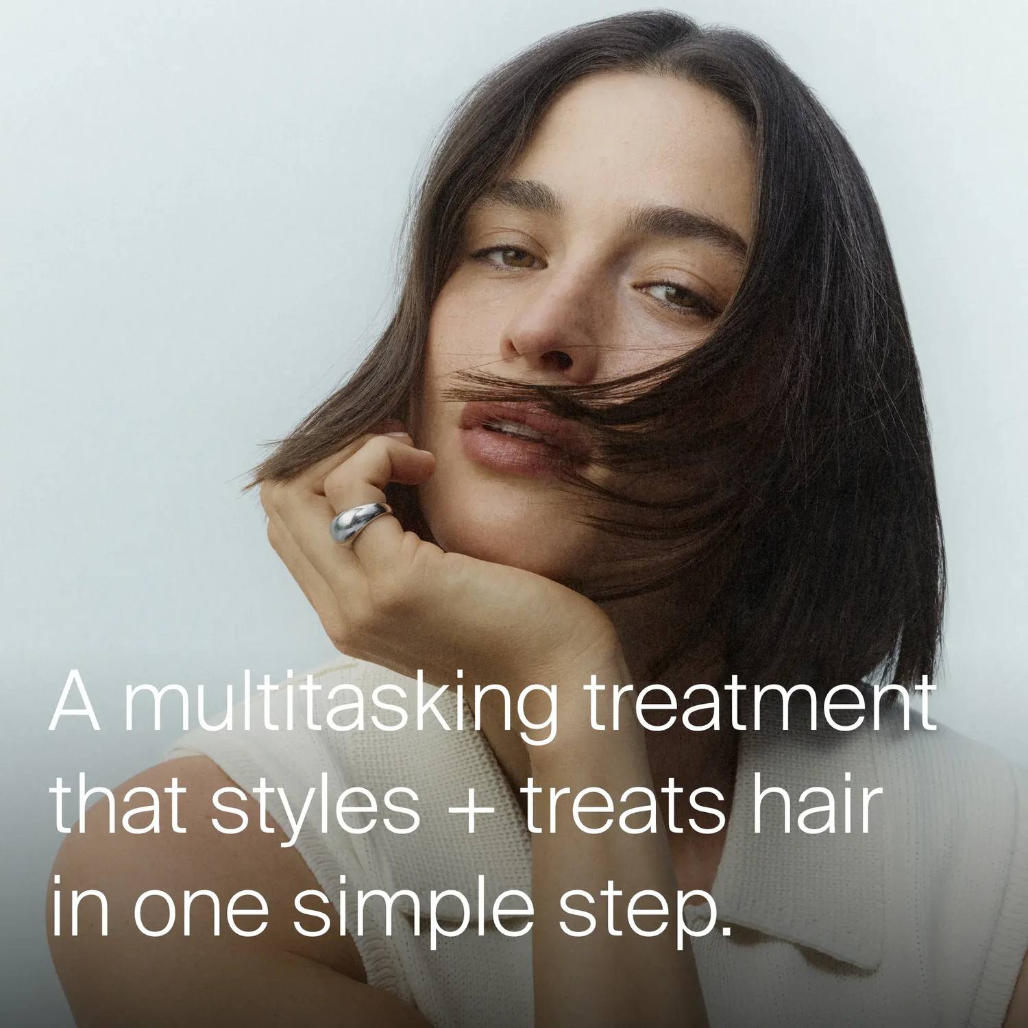 Woman with a sleek dark bob showing Perfect Hair Day 5-in-1 Styling Treatment styles and treats hair in one step