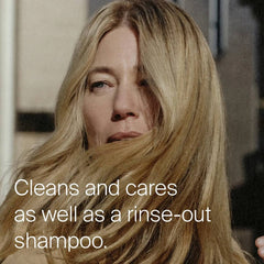 Woman with long glossy blonde hair showing Advanced Clean Dry Shampoo cleans and cares like a rinse-out shampoo