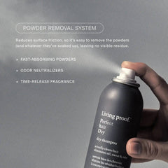 Hand spraying Living Proof Perfect hair Day Dry Shampoo with powder removal system and odor neutralizers