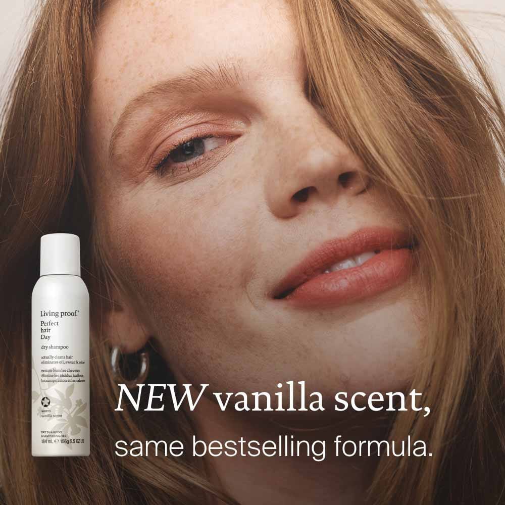 Woman with auburn hair beside Perfect hair Day Dry Shampoo in new warm vanilla scent with the same bestselling formula