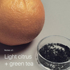 Orange and loose green tea leaves showing the light citrus and green tea scent of Perfect hair Day Shampoo
