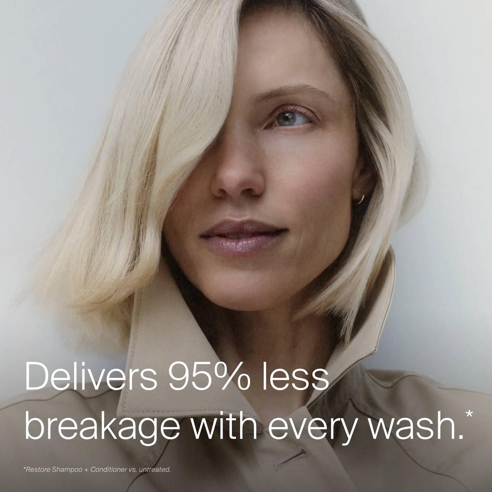 Woman with sleek platinum blonde bob showing Restore Shampoo and Conditioner deliver 95% less breakage