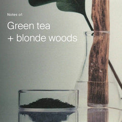 Green tea leaves and a wood stick in lab glass showing the green tea and blonde woods scent of Density Serum