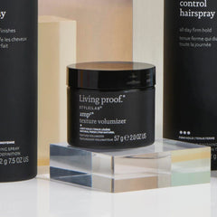 Amp2 Texture Volumizer jar on an acrylic block with Style Lab Flex Hairspray and Control Hairspray behind it