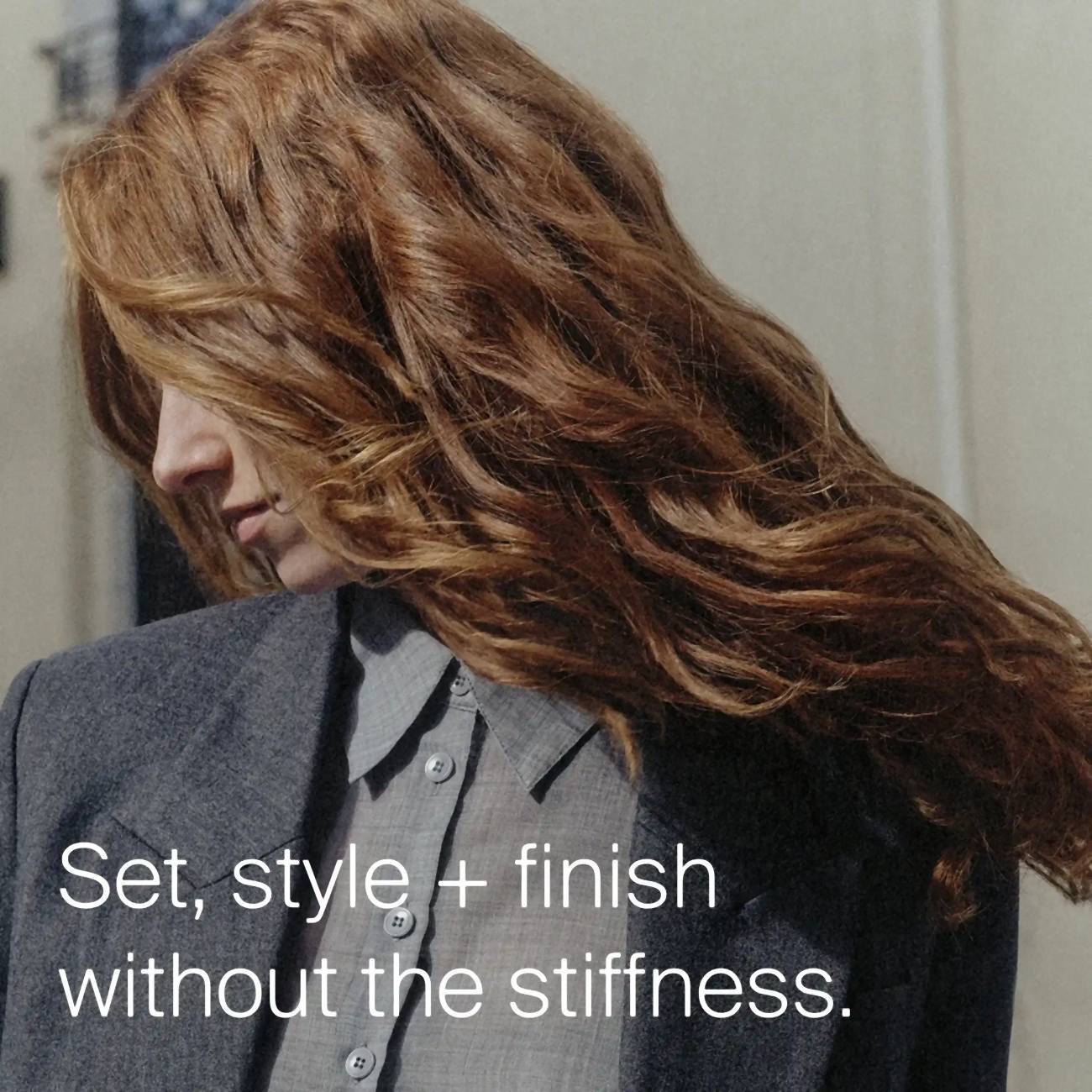 Woman with long red wavy hair showing Flex Hairspray sets styles and finishes hair without the stiffness