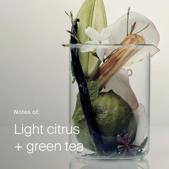 Lime vanilla jasmine and tea leaves in a beaker showing the citrus and green tea scent of Living Proof Triple Bond Complex