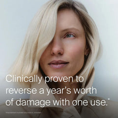 Woman with smooth platinum blonde hair showing Living Proof Triple Bond Complex reversing a year of damage in one use