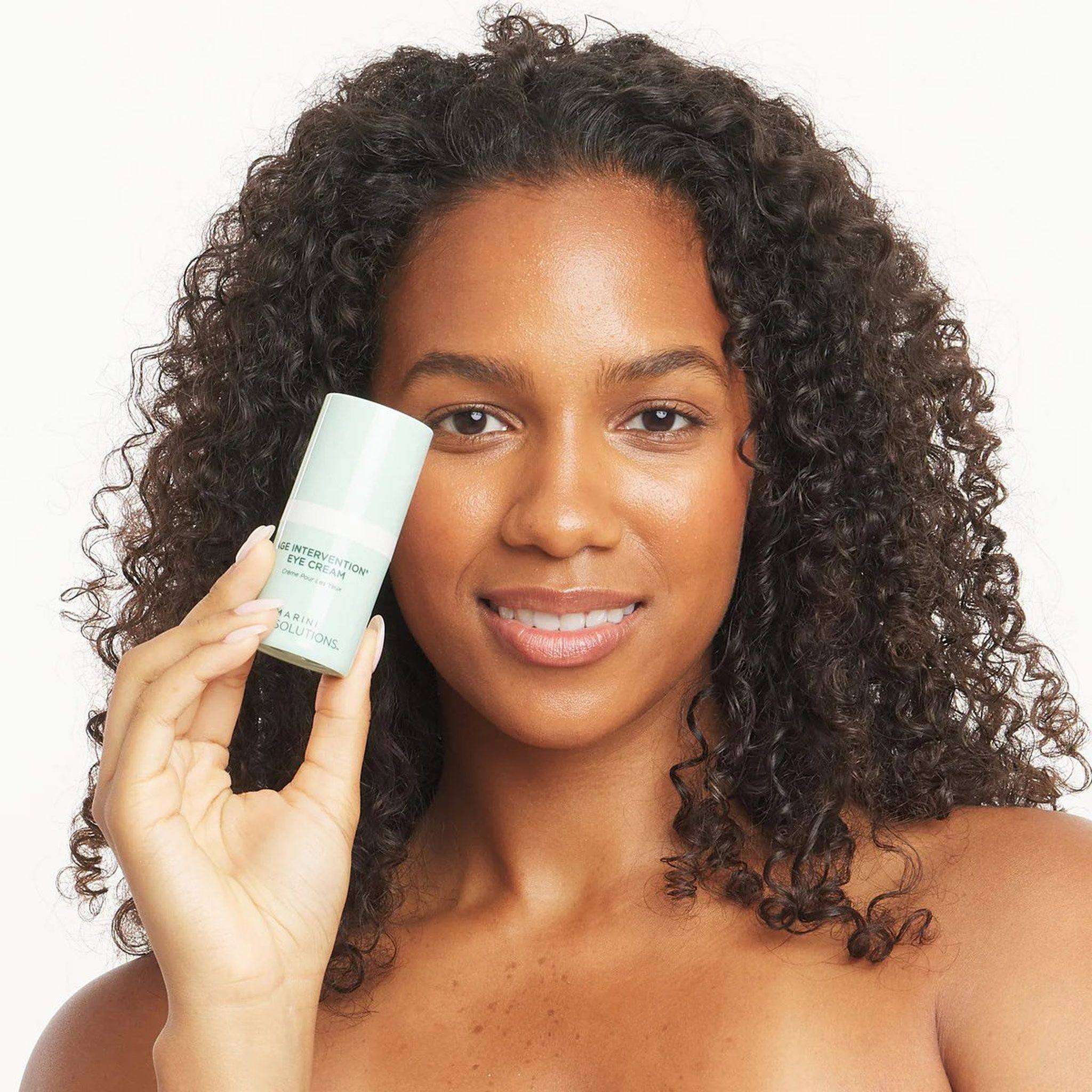Model holding Marini Skinsolutions Age Intervention Eye Cream anti-wrinkle retinol eye treatment