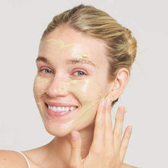 Woman applying Marini Skinsolutions Skin Zyme enzyme face mask to her skin