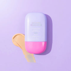 Naked Sundays CabanaMilk tinted SPF50 barrier fluid bottle with a tinted lotion swatch on purple