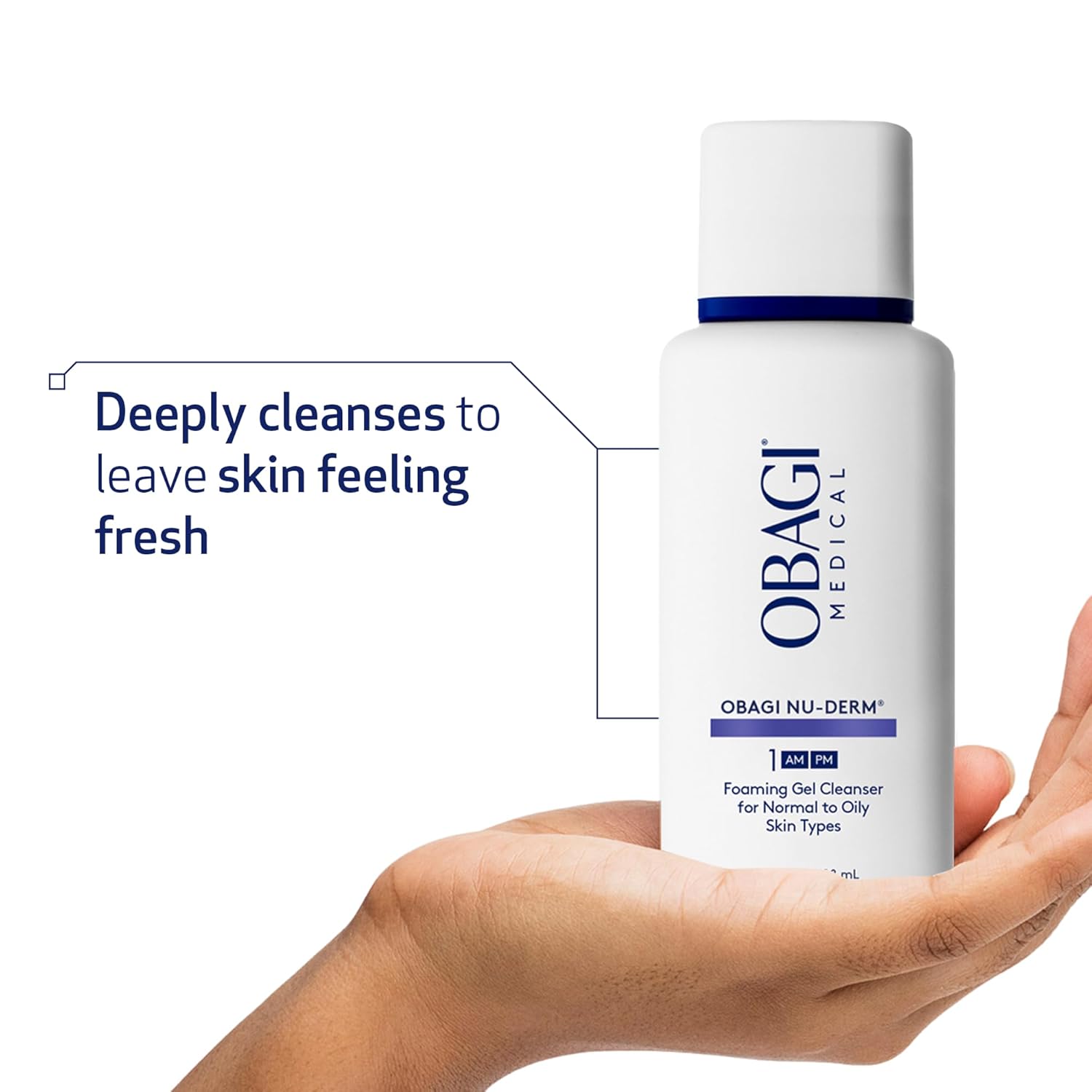 Obagi Nu-Derm Foaming Gel Cleanser bottle held in a hand with text about deep cleansing.