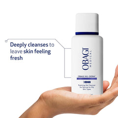 Obagi Nu-Derm Foaming Gel Cleanser bottle held in a hand with text about deep cleansing.