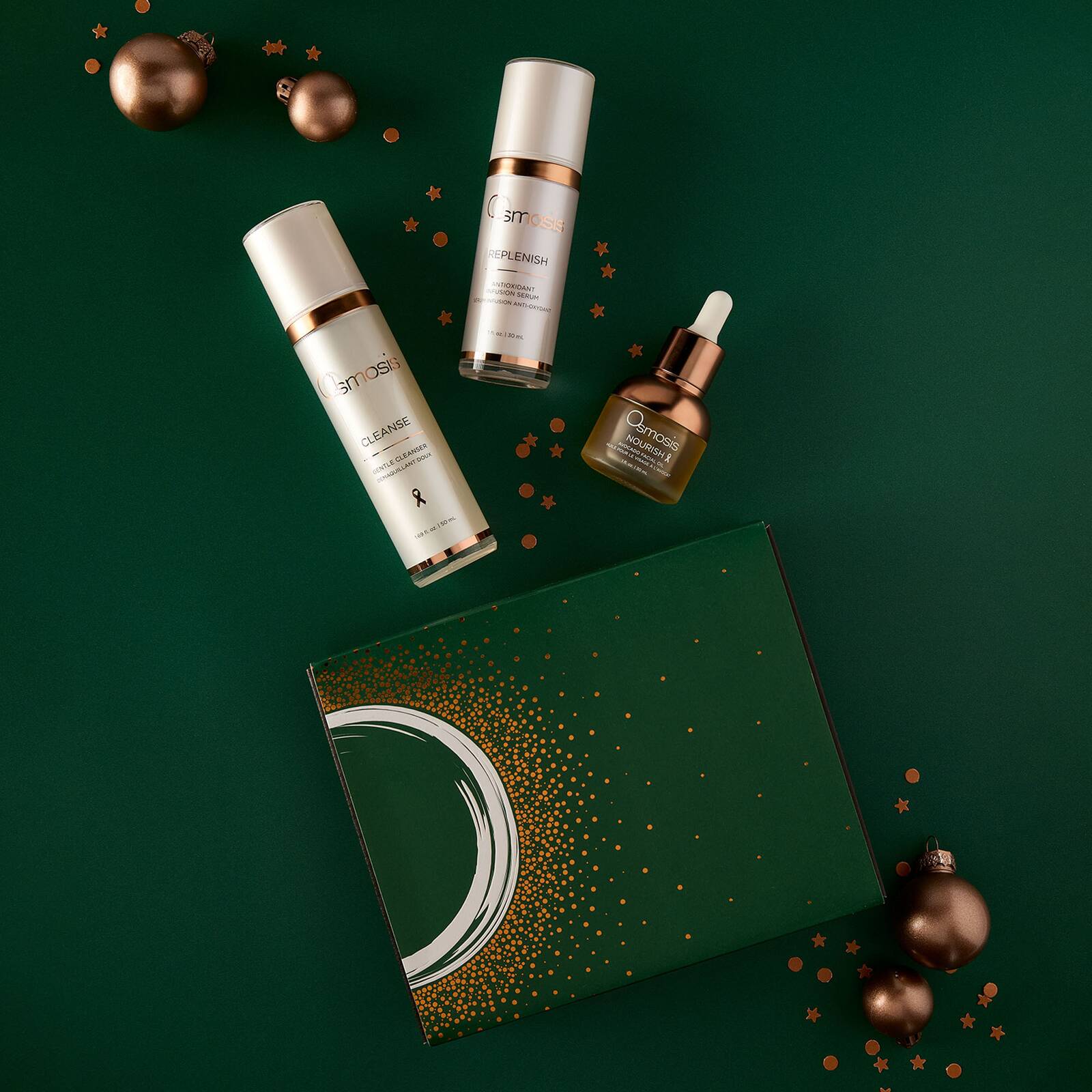 Osmosis Let It Glow Kit with Cleanse Replenish and Nourish on a green background with gold ornaments