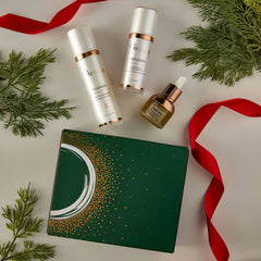 Osmosis Let It Glow Kit with Cleanse Replenish and Nourish styled with pine branches and red ribbon