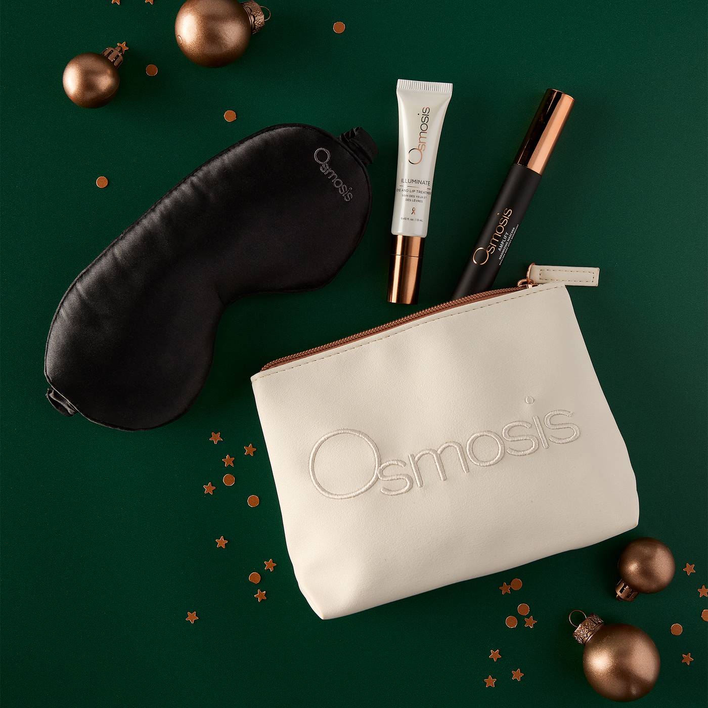 Osmosis Merry and Bright Eye Kit styled on a green background with gold ornaments and confetti
