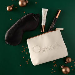 Osmosis Merry and Bright Eye Kit styled on a green background with gold ornaments and confetti