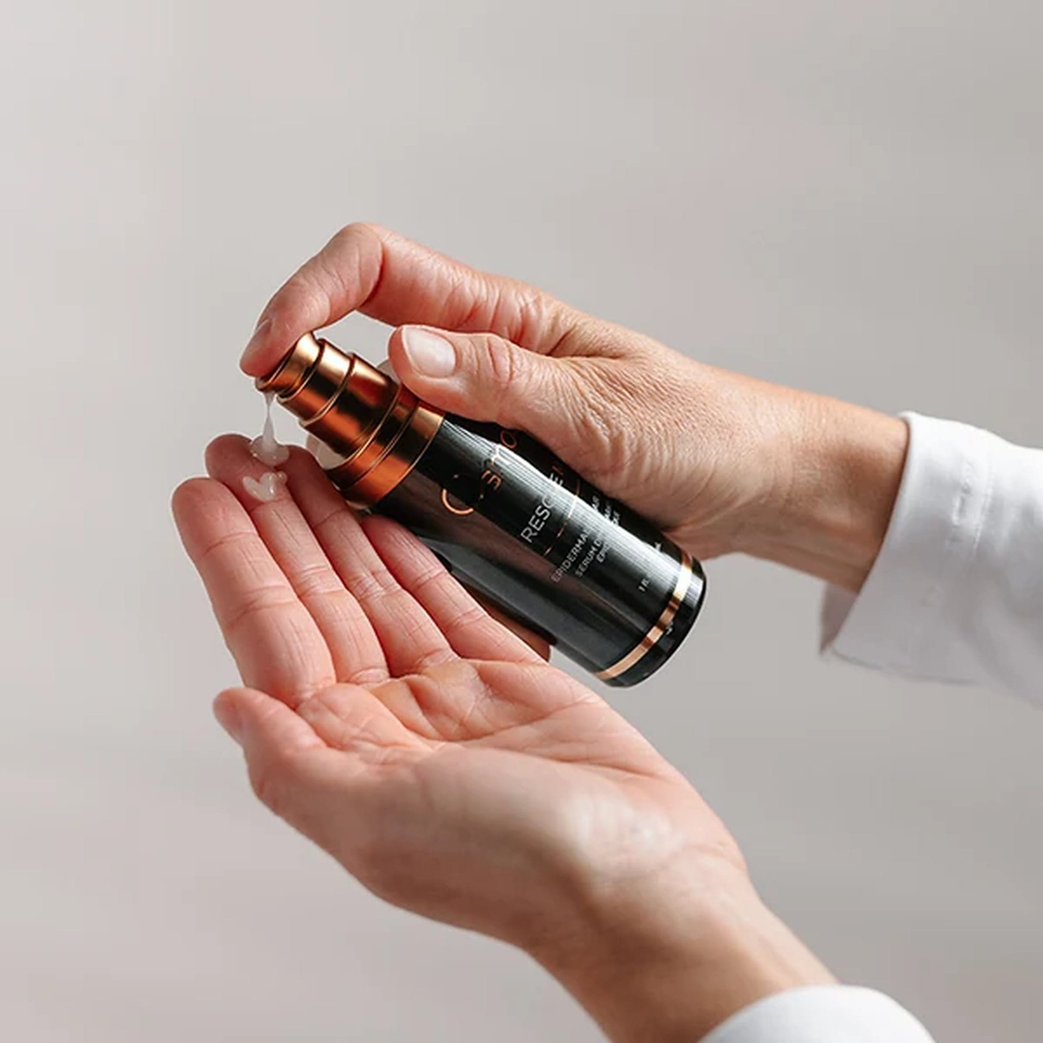 Osmosis Rescue MD repair serum pumped into palm showing how to apply 2 pumps to clean skin