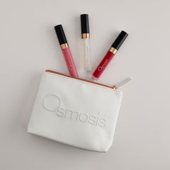 Osmosis Under the Mistletoe Lip Kit with three lip glosses and cosmetic bag on a white background