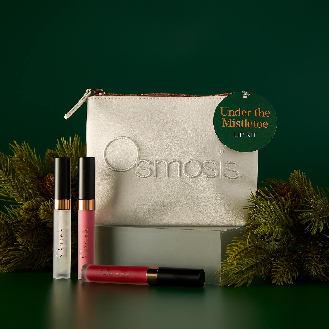Osmosis Under the Mistletoe Lip Kit on a pedestal with an Under the Mistletoe gift tag