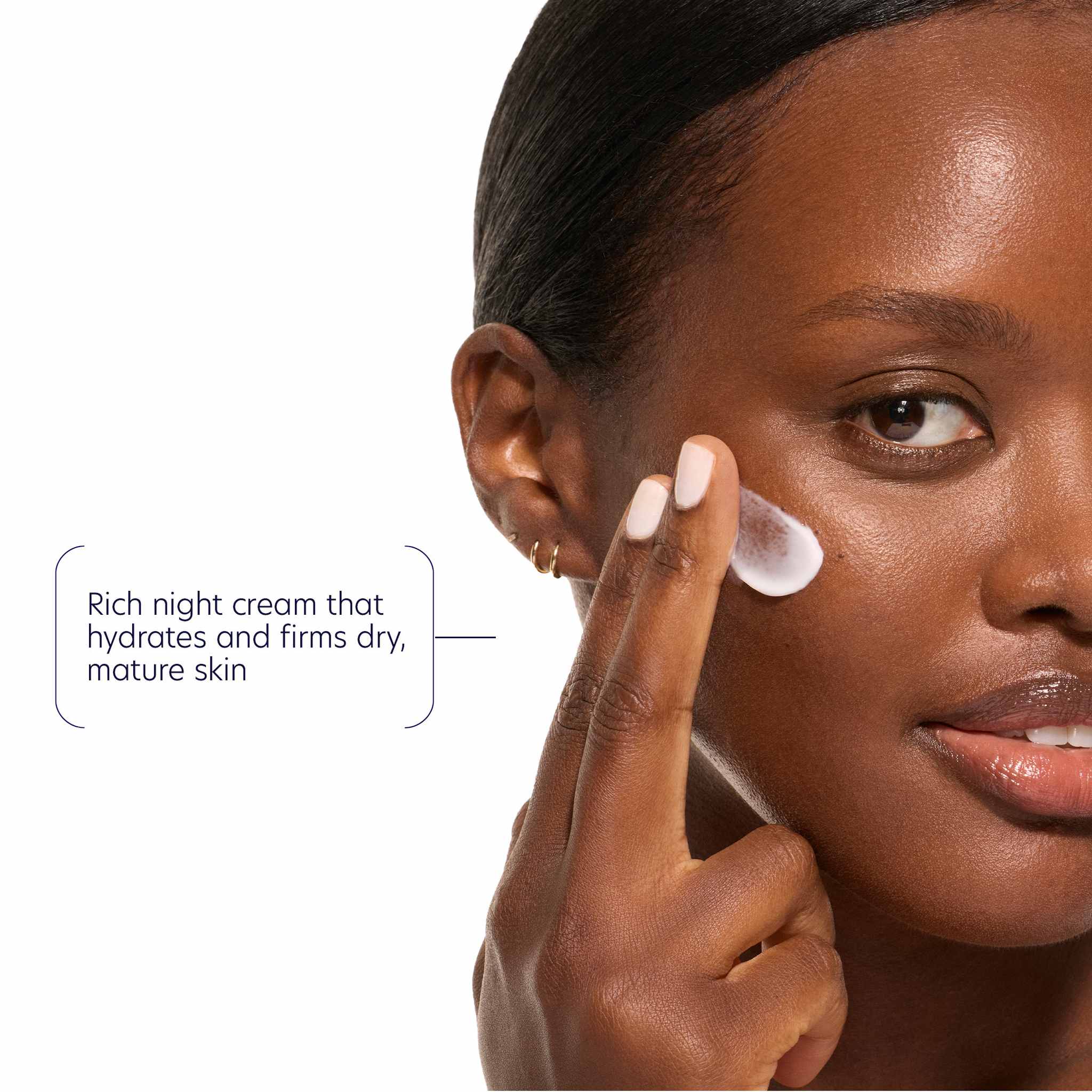 Woman applying rich night cream for hydrated firmer mature skin