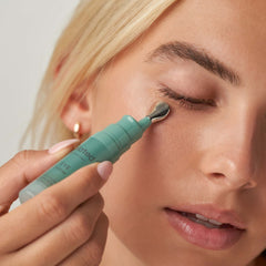 Plated Eye Serum metal applicator gliding along the under eye area